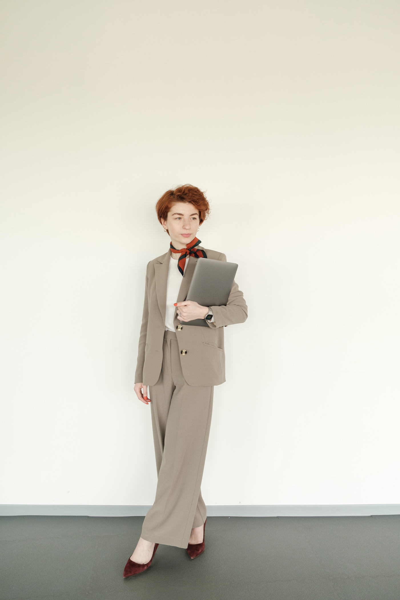 A Woman in Suit Carrying a Laptop